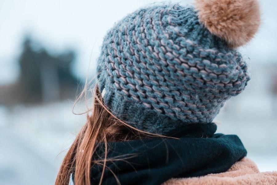 Woman wearing a blue bobble hat