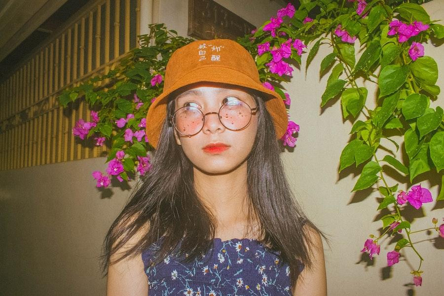 Woman with glasses wearing a corduroy bucket hat