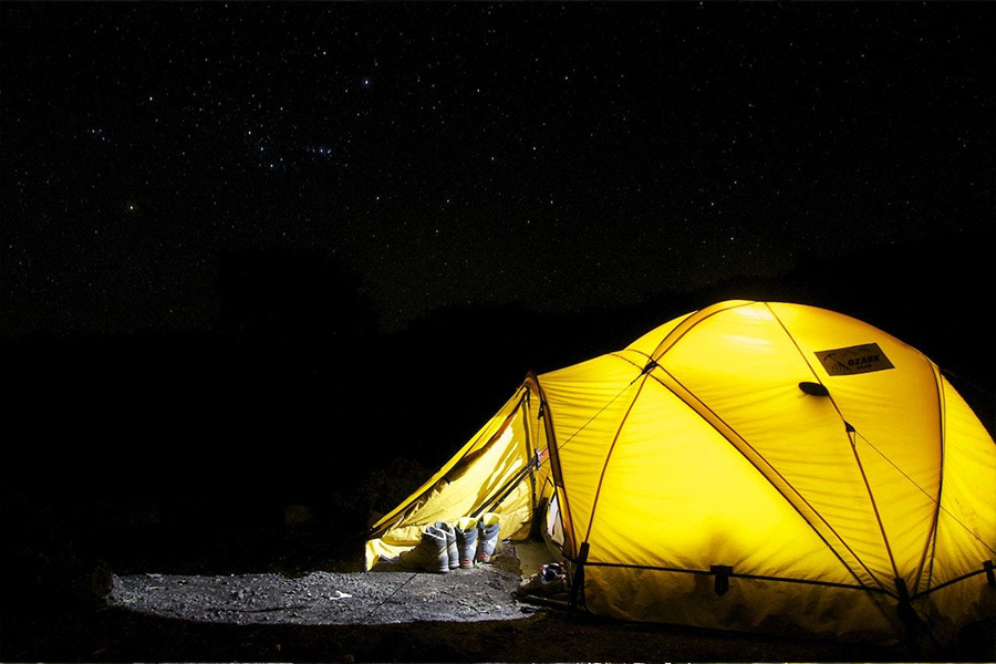 Yellow tent illuminated by a portable power station