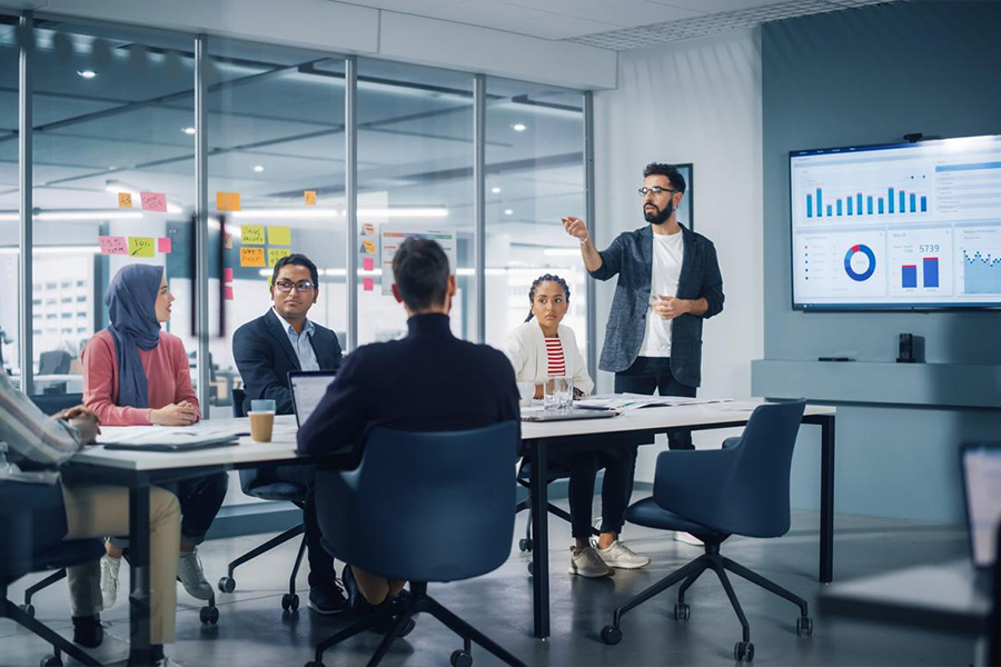 A businessman leads a meeting with managers