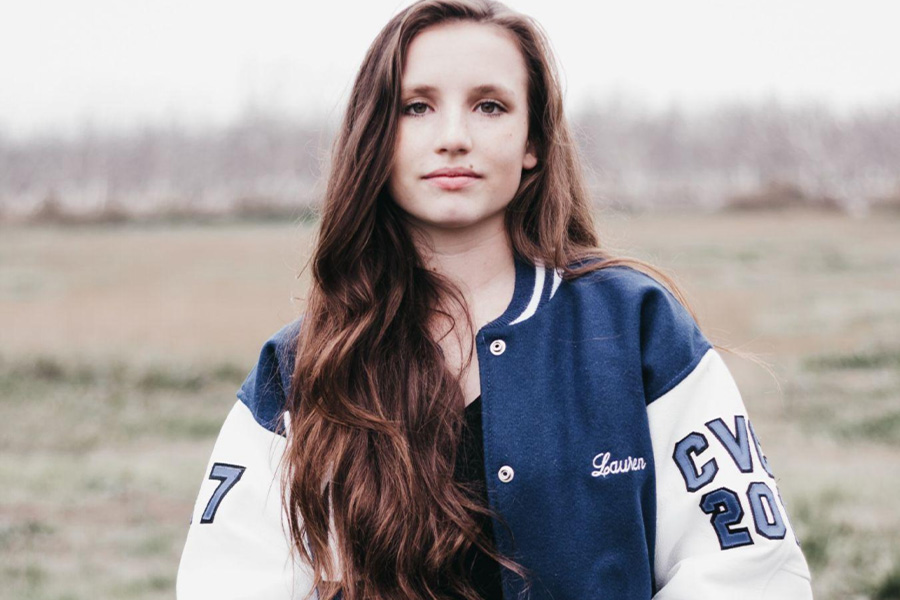 A girl wearing a varsity jacket