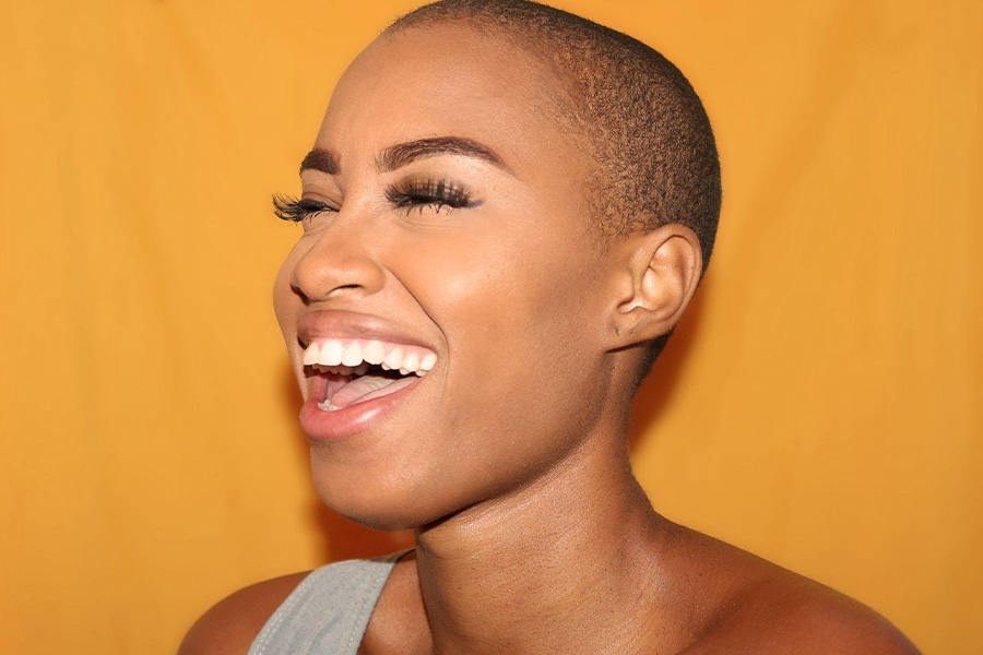 A laughing woman wearing natural makeup