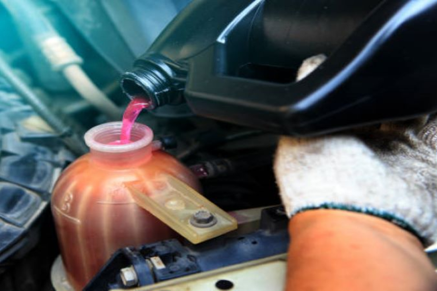 A man refilling refrigerant in an air conditioning system