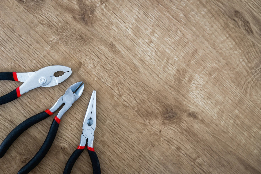 A pair of pulled pliers lying on a surface