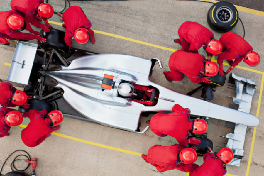 A race team changing sporty tires at a pit stop