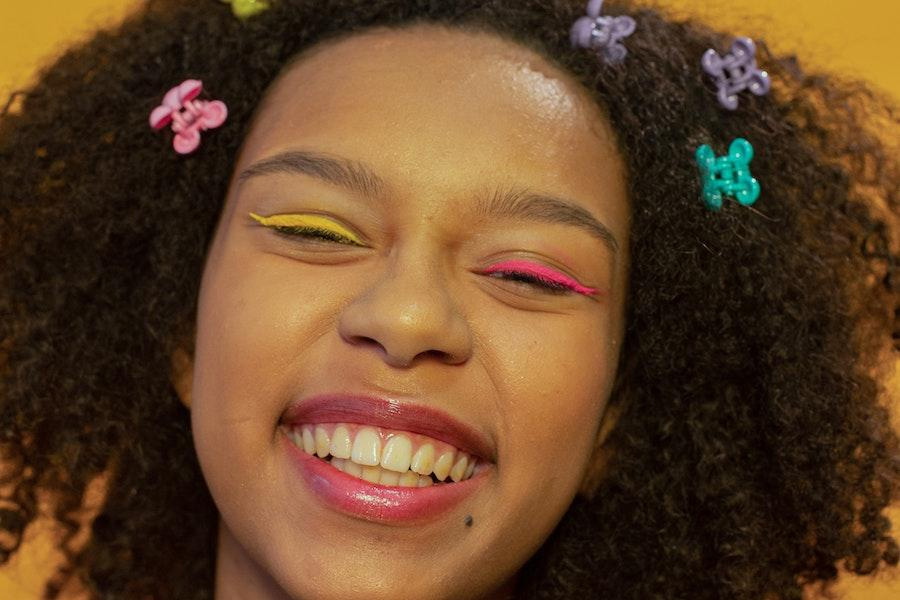 Beautiful smiling woman with multiple mini claw clips