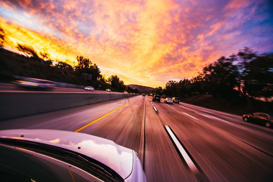 Car driving in summer sunset