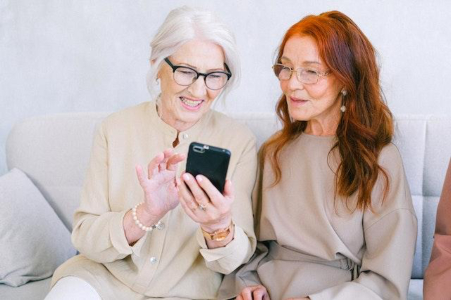 Cheerful senior women shopping online on a smartphone