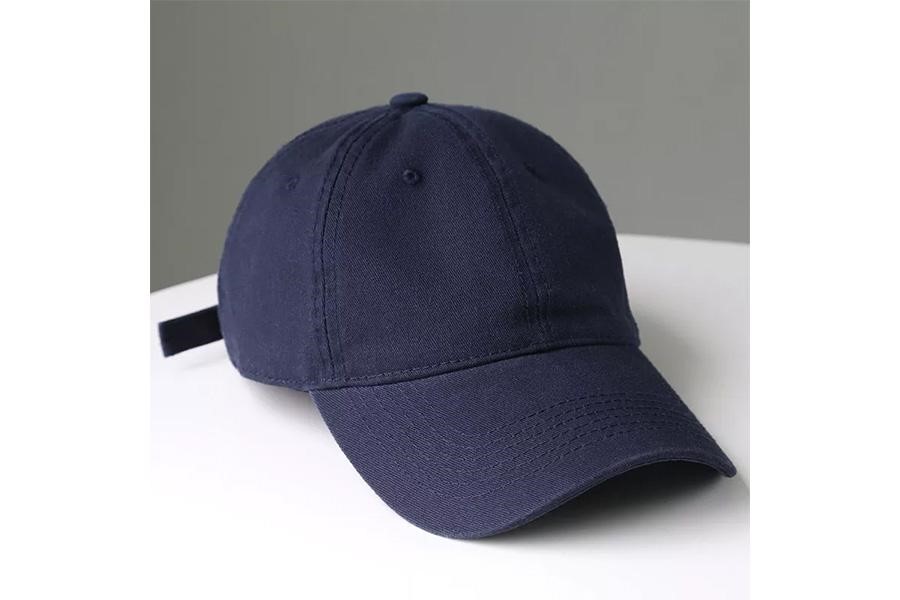 Dark blue baseball cap sitting on white table