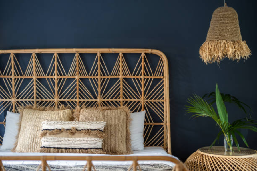 Dark blue bedroom with wicker bed and wicker nightstand