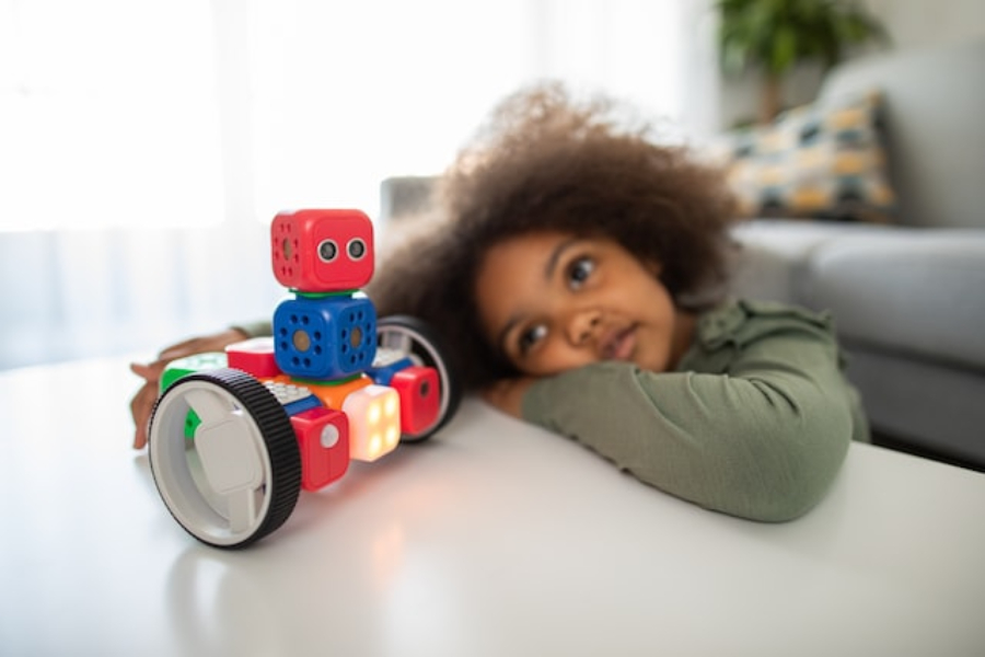 Girl playing with a toy robot