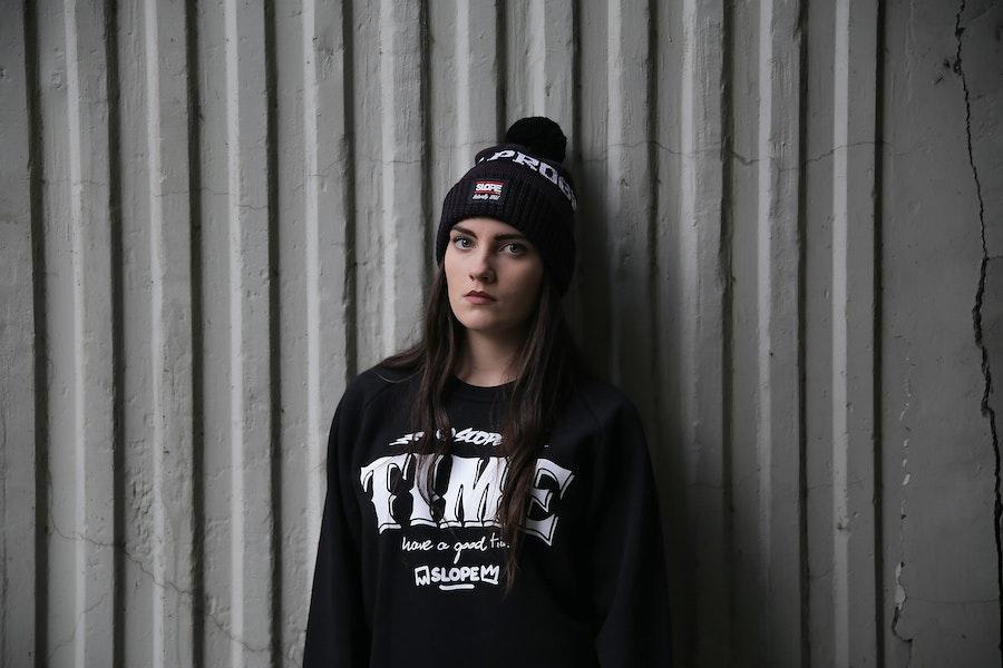 Lady posing in a black logo-patch beanie