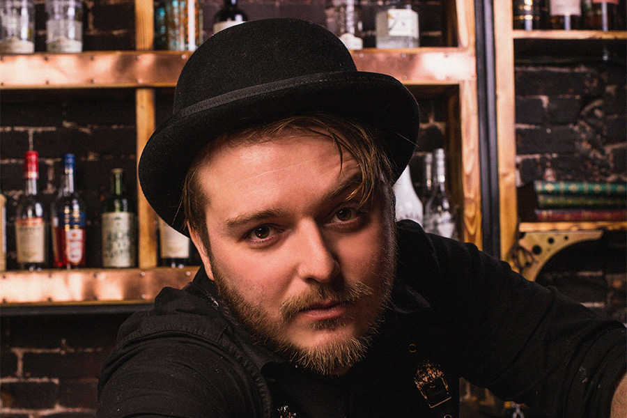 Man in a bar rocking a black bowler hat