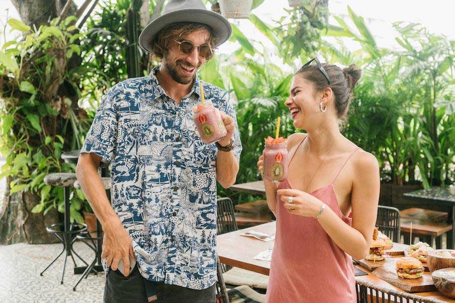 Man in a resort shirt standing next to a woman