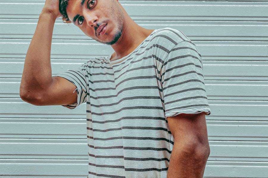 Man posing with white and black striped nautical shirt