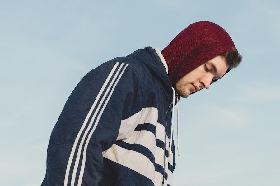 Man rocking a blue zip-up jacket with white stripes