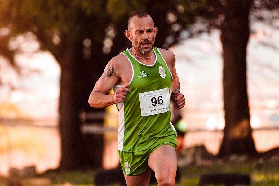 Man running in a green and white paneled sportswear combo