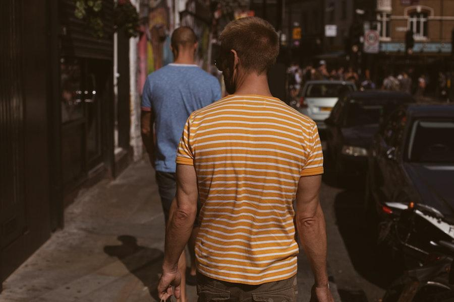 Man wearing orange and white striped nautical shirt