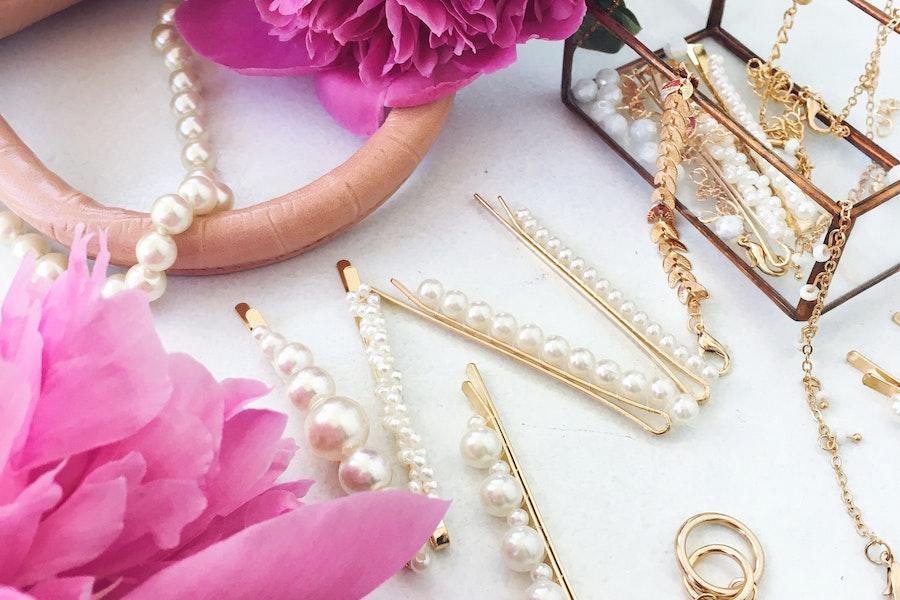 Multiple pearl hair clips on a white table