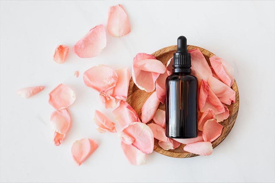 Perfume bottle with rose petals