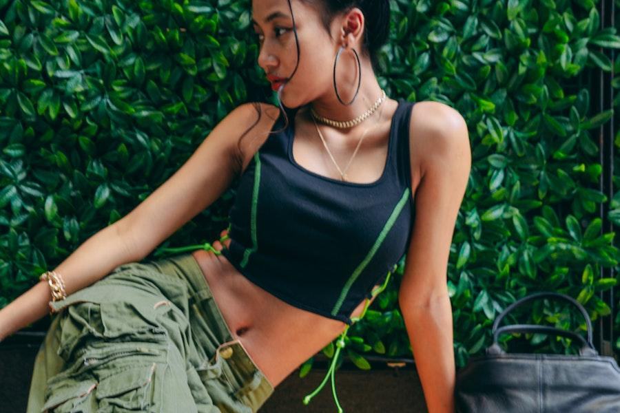 Posing woman wearing a cropped tank and cargo pants