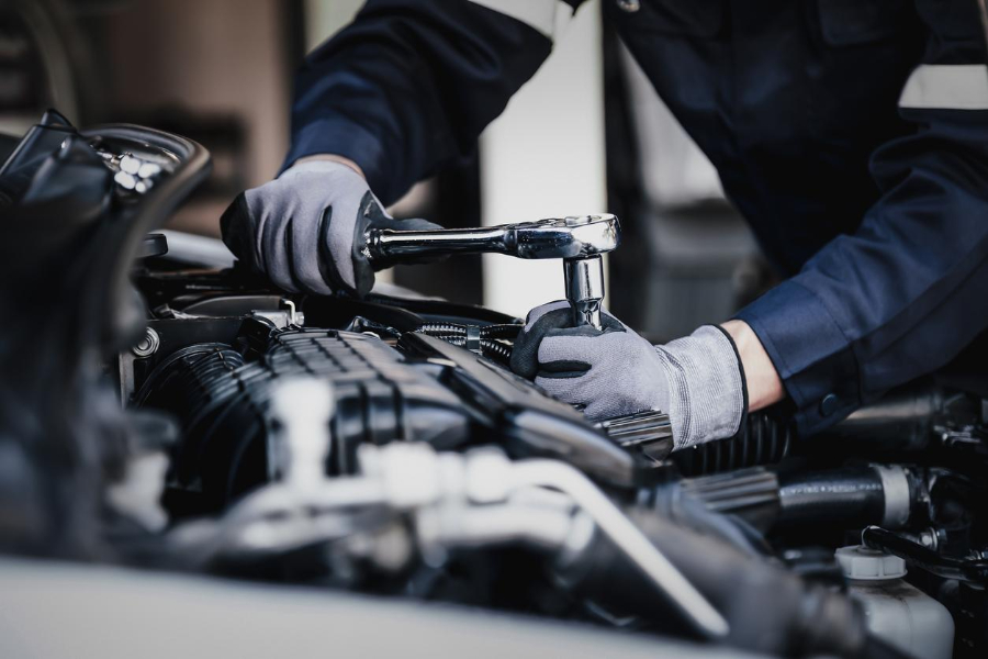 Professional mechanic working on the engine of the car