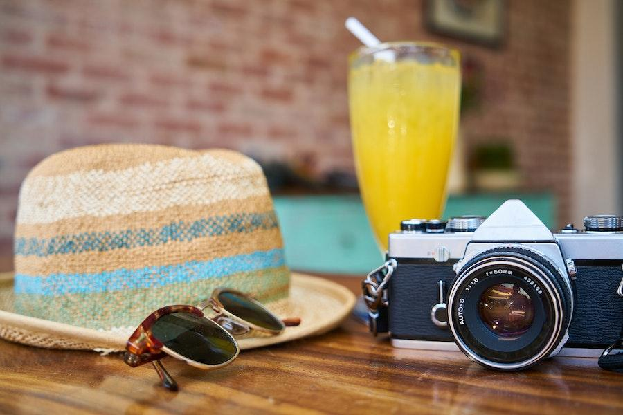 Quality hat on a table with sunglasses and other items