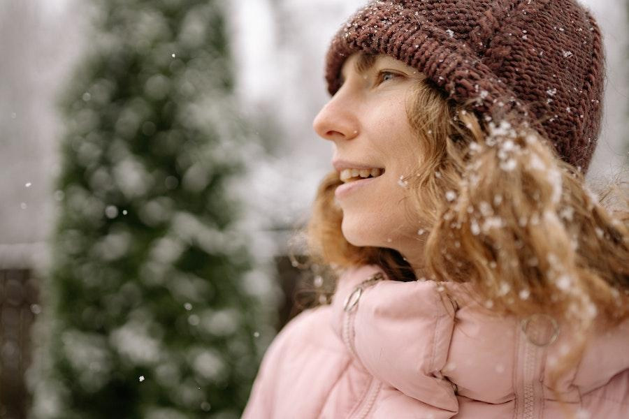 Smiling woman wearing a brown wool beanie