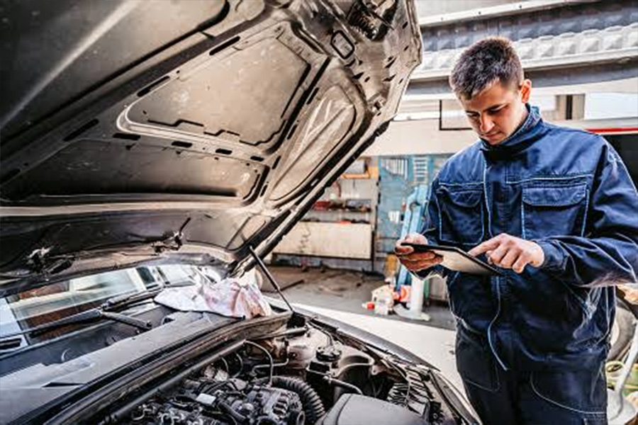 Technician performing maintenance check on vehicle