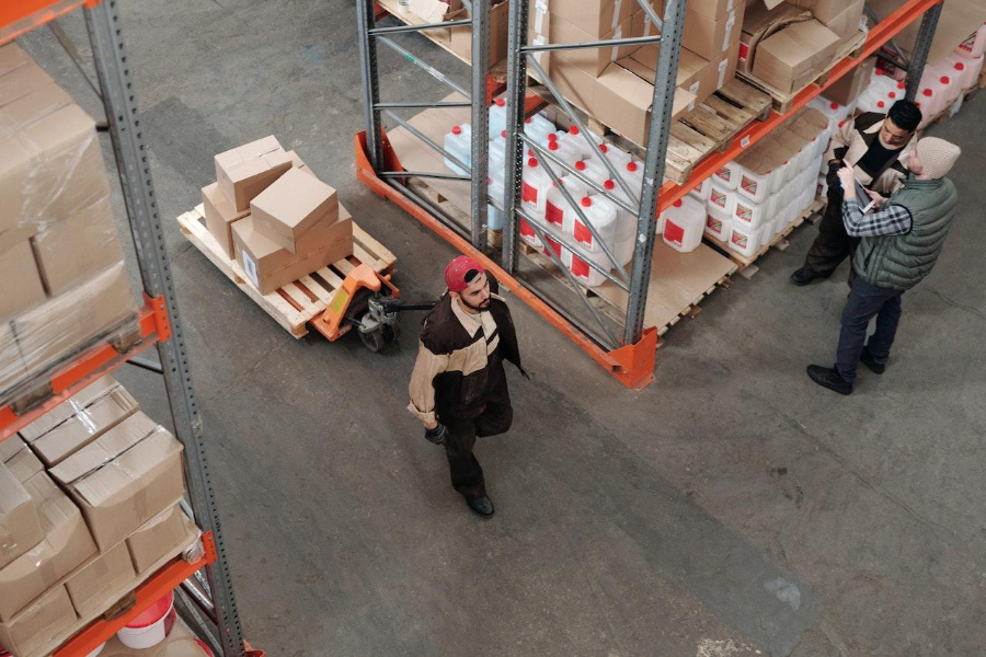 Three men working in a warehouse