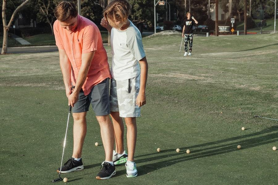 Two men playing golf in trendy golfwear