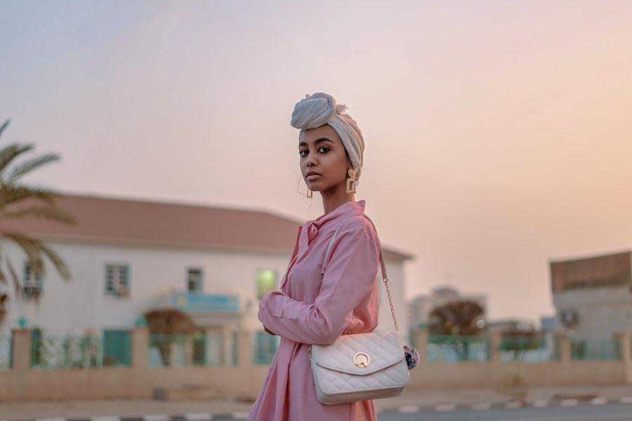 Woman folding her arms while rocking a pink dress