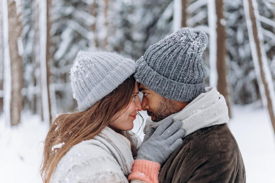 Woman posing with a man while wearing a skull beanie