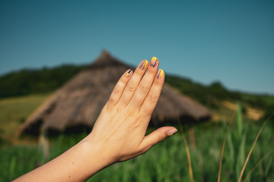 Woman showing natural tone nails