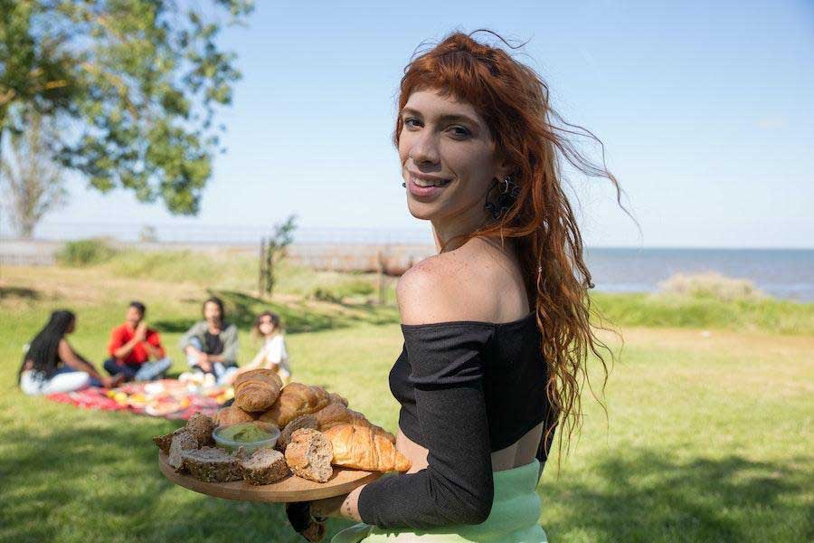 Woman smiling while wearing a black long-sleeved crop top