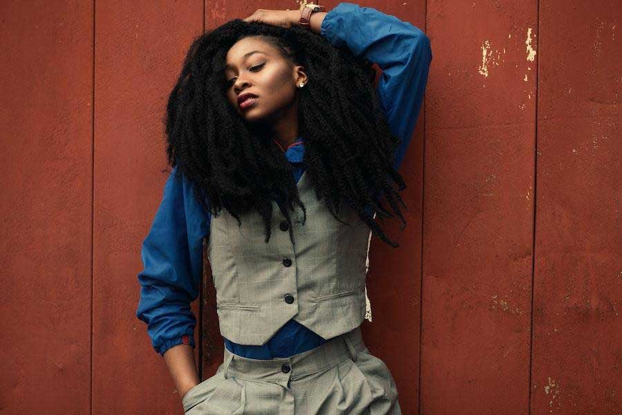 Woman wearing a blue button shirt and ash vest