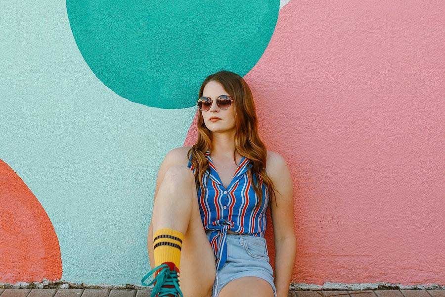 Woman wearing a colorful shirt and shorts