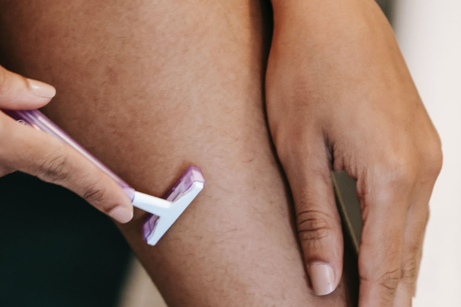 Close-up of a woman shaving her leg