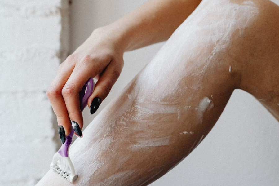 Woman using shaving cream