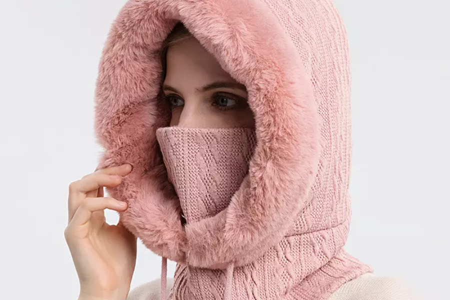 Woman wearing a fur lined pink winter balaclava